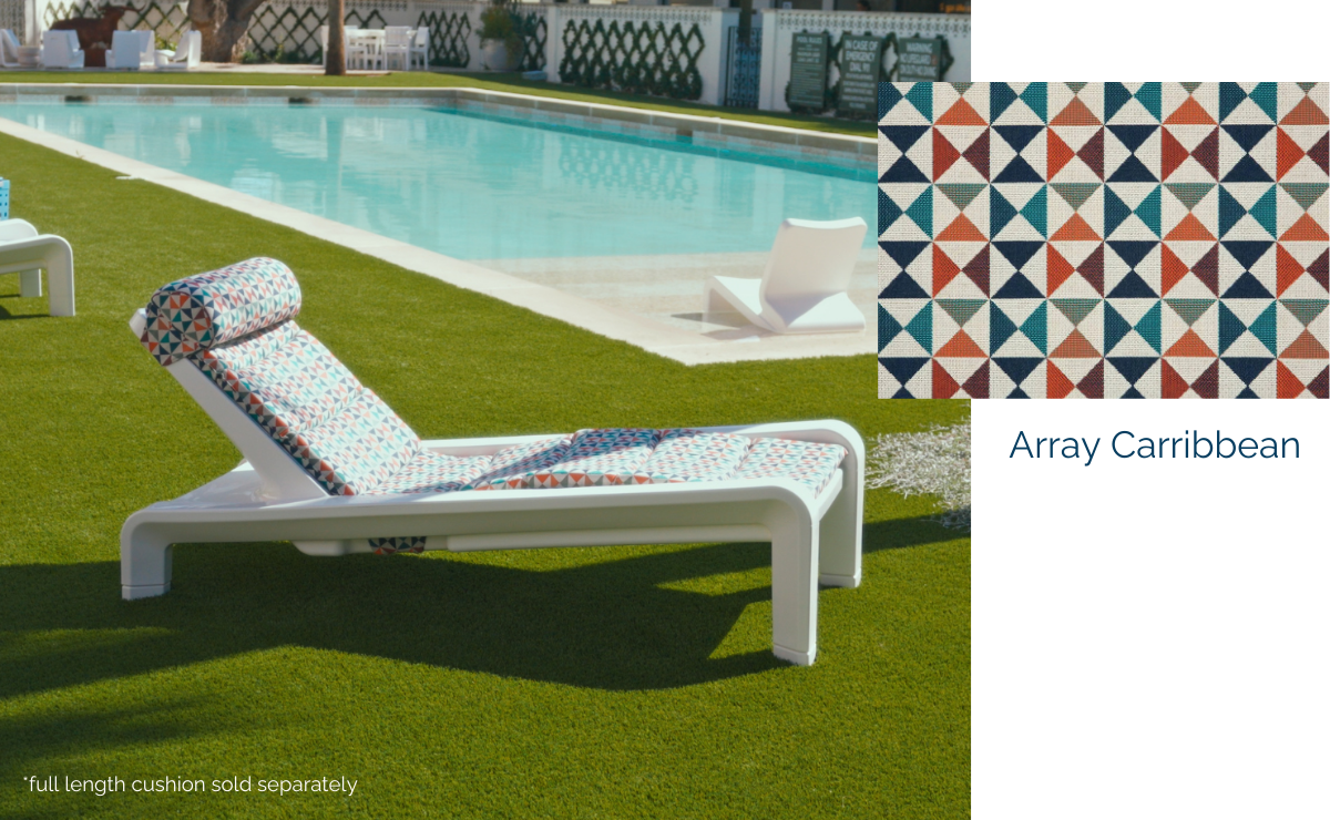 White outdoor chaise lounge with Array Caribbean geometric print cushion beside a swimming pool
