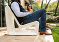 Load image into Gallery viewer, People sitting on a modern Tupelo Goods outdoor lounge chair on a patio
